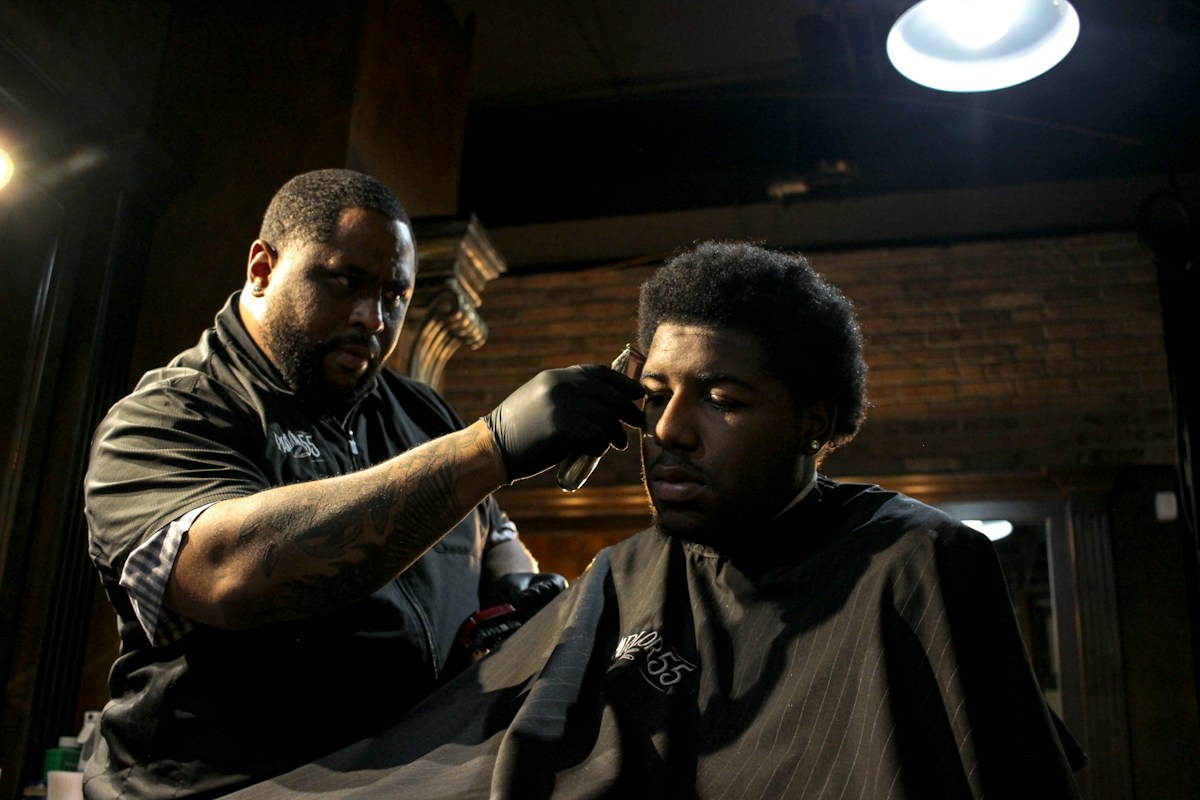 Barber carefully refining a haircut